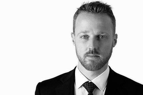 Black and white professional headshot of Blyth Staley, senior adviser and partner at Actonwealth, dressed in a formal suit, conveying a serious and focused expression.