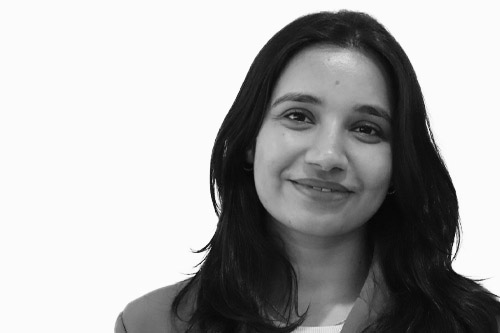 ortrait of Pratistha Khatiwada, the Operations Manager at Actonwealth, smiling gently in a black and white photo.